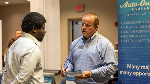 Student speaking with Auto Owners at Accounting and Finance Fair